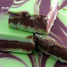 several pieces of chocolate and green candy on a plate