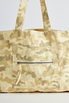 Large size tote bag by BDG & only at UO. Washed cotton bag with a spacious main compartment and a zip pocket at the front. Includes twin carry handles. Features BDG large tote bag Classic shoulder bag Washed cotton Outer zip pocket Carry handles Content + Care 100% Cotton Spot clean Imported | BDG Large Tote Bag in Camo at Urban Outfitters Cotton Beach Bag With Pockets For Travel, Cotton Beach Bag With Pockets For Everyday Use, Beige Cotton Bag With Zipper Closure, Beige Cotton Canvas Bag With Zipper Closure, Cotton Weekender Bag With Zipper Closure, Cotton Beach Bag With Pockets, Cotton Canvas Bag With Zipper Closure For Shopping, Cotton Canvas Bag With Zipper For Shopping, Cotton Canvas Tote Bag With Zipper Closure