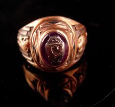 This 10kt rose gold ring has a very interesting history ( see photo) . I am not sure what school it goes to but there are Lions on each side if that help. The center stone is a garnet. 8-3-20goat Gold Round Cameo Signet Ring, Collectible Art Deco Rose Gold Jewelry, Ancient Style Yellow Gold Signet Ring Gift, Ancient Intaglio Ring Jewelry, Luxury Antique Cameo Signet Ring, Ancient Yellow Gold Intaglio Ring, School Rings, Peter Do, Head Ring