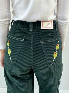 Take your fashion to new heights with these olive-embroidered Dylan Pants! High-rise, rigid, and non-stretch - they're made for a martini with style! 🍸👖 Details High-rise, rigid, non-stretch jeans in a green corduroy fabric with carpenter jean details featuring embroidered olives on the back pockets.100% CottonMachine wash cold, Tumble dry lowMade in CaliforniaModel is 5'8" and wears a size 2 Size Waist Hips Inseam Front Rise 0 25" 33" 29.5" 11.75" 2 26" 34" 29.5" 12.25" 4 27" 35" 29.5" 12.75" Eclectic Style Fashion, Unique Style Outfits, Olive Outfit, Eclectic Clothing Style, Olive Martini, Eclectic Grandpa, Olive Pants, Green Corduroy, Lisa Says Gah