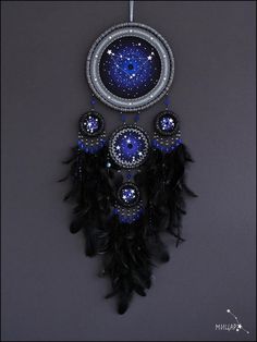 a black and blue dream catcher hanging on a wall