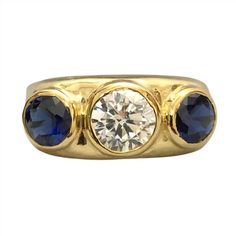 Elevate your style with this stunning Bezel Set Blue Sapphire CZ Diamond 3 Stone Ring. Crafted with a 14k yellow gold finish on 925 sterling silver, the vibrant blue sapphire combined with dazzling CZ diamonds creates a striking contrast, making it a timeless and versatile piece that will surely make a statement by adding a touch of sparkle to any outfit. This exquisite ring exudes elegance and sophistication, combines elegance and glamour effortlessly, and is a must-have for your jewelry collection. It is perfect for adding a touch of glamour to any outfit, making it the perfect accessory for any special occasion or as a thoughtful gift for a loved one. The Ring is made of 925 Sterling Silver set with Simulants of Blue Sapphire ( CZ)  and Diamond ( CZ)  ( Man Made Imitations) ,Main stones Classic Gold Three-stone Sapphire Ring, Classic Gold Three Stone Sapphire Ring, Classic Gold Sapphire Ring With Three Stones, Luxury Gold Three-stone Sapphire Ring, Gold Sapphire Three Stone Jewelry, Gold Sapphire Jewelry With Three Stones, 3 Stone Ring, Sapphire Rings, 3 Stone Rings