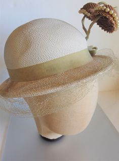 "Crazy cute off white panama straw hat from the 1930's with two jutting brown fabric florals on green stalks trimmed in faux pearls. The hat measures 20\" on the inside circumference and the crown of the hat is about 4\" high. Each flower measures 2\" in diameter and they stand up about 3\". It has a grosgrain ribbon bow. The hat is in great condition for its age with only tearing of the netting and some soiling of the inside rim. It is marked \" Genuine Panama\" on the inside band. Please email Cream Straw Boater Hat For Kentucky Derby, Vintage Fitted Brown Panama Hat, Fitted Vintage Brown Panama Hat, Fitted Retro Cream Hat, Retro Fitted Cream Hat, Retro Cream Hat, Vintage White Fedora Hat, Fitted Cream Hat For Vintage Events, Vintage White Cloche Hat