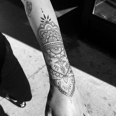 a black and white photo of a person's foot with a tattoo on it