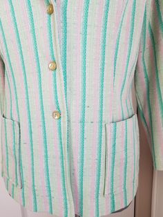 "Cute little blazer style jacket. The fabric is a poly knit that has shades of green and pink stripes. Kinda reminds me of a watermelon! Has two patch pockets on the front, and 3 buttons. Label read, \"West Coast Fashions California\" Condition: Fair to good, but definitely wearable! There is a bit of verall pilling, and a few pulls in the fabric, which isn't that noticeable. Measurements Bust: up to 41\" Length: 23\"" Green Spring Blazer With Buttons, Spring Green Blazer With Buttons, Green Blazer With Buttons For Spring, Spring Striped Buttoned Outerwear, Striped Buttoned Outerwear For Spring, Green Summer Outerwear With Buttons, Retro Green Blazer For Spring, Summer Striped Long Sleeve Blazer, Vintage Striped Spring Outerwear