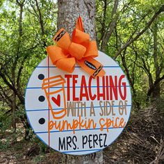 a sign on a tree that says teaching with a side of pumpkin spice mrs perez