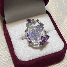 a ring with amethyst purple stones in it