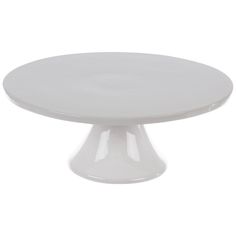 a white cake plate sitting on top of a table