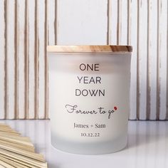 a candle with the words one year down on it next to some matchesticks