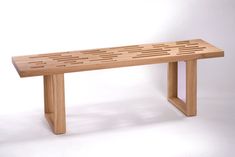 a wooden bench sitting on top of a white floor