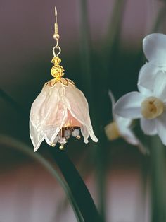 Beautiful handmade clear cold porcelain, and beads created an unique and one kind earrings. Gold tone hardware used to finish. It will look beautiful with any outfit in any occasion. Earring with theirs sparkles will highlight the sparkling of your eyes. Light weight, and unique they will bring you joy and brighten your image. Elegant Czech Glass Flower Earrings, White Bead Caps Earrings For Gift, Elegant Gold Flower Earrings Polymer Clay, Gold Flower-shaped Polymer Clay Earrings, Gold Whimsical Polymer Clay Earrings, Whimsical Gold Polymer Clay Earrings, Gold Flower Earrings With Czech Glass, Handmade Gold Flower Earrings In Polymer Clay, Handmade Gold Polymer Clay Flower Earrings