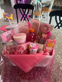 a pink basket filled with lots of different items