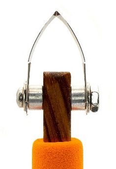 an orange object with two metal handles and a wooden block on it's side