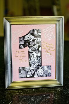 a pink and silver frame with some pictures on the inside is holding a number one