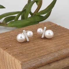 "Simple Two Pearl Earrings that can easily dress up any outfit for any occasion! Top Pearl - 6mm Bottom Pearl - 8mm Pearl Type - Shell Pearl Stud Earring Material - Solid Sterling Silver Stud Length - 12mm Stud Width - 4mm Stud Thickness - 2mm Post Length - 9.5mm (3/8\") Post Thickness - 20 gauge (0.81mm) Ear Back Type - Push On Ear Back Material - Sterling Silver Sold As a Pair Finish - Matte or Polished The Finish option in the listing pictures is the matte finish" Minimalist White Sterling Silver Earrings, Silver Minimalist Pearl Earrings For Anniversary, Minimalist Sterling Silver Pearl Earrings In Silver, Minimalist Nickel-free Pearl Earrings For Formal Occasions, Minimalist Silver Pearl Earrings For Anniversary, Minimalist Silver Sterling Silver Pearl Earrings, Minimalist Hypoallergenic Sterling Silver Pearl Earrings, Minimalist Hypoallergenic Pearl Earrings For Formal Events, Hypoallergenic Minimalist Sterling Silver Pearl Earrings