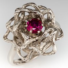 This exquisite ring features an open floral design, centered with a round cut ruby, weighing 0.50 carats, in a six-prong setting. The ring measures 18.6mm at the top, rises 8.7mm above the finger, tapering to 2.3mm wide and 1.3mm thick at the base of the shank. This ring is currently a size 7. The ring shows a lovely natural patina and the ruby shows some natural surface reaching inclusions which will appear like small chips with a very close eye. Vintage Ruby Rings, Ruby Engagement Rings, Antique Cocktail Ring, Ruby Ring Vintage, Wedding Anniversary Presents, Ruby Rings, 40th Wedding Anniversary, Ruby Engagement Ring, Red Gemstones