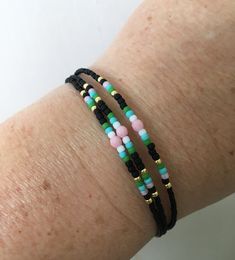 This three-strand bracelet features Japanese glass beads (in black, gold, green, turquoise, white and pink) and Czech fire-polished beads in pink. Diameter: 7.8 inches (including the closure). Please contact me for custom sizing. My store: www.almasurfside.etsy.com Facebook: www.facebook.com/almasurfside YouTube: https://www.youtube.com/@almasurfside-surfandbeachj1170 Thanks for shopping at Alma Surfside! Adjustable Multi-strand Bracelets With Tiny Beads, Adjustable Multicolor Double Strand Beaded Bracelets, Adjustable Double Strand Bracelets With Colorful Beads, Colorful Beads Double Strand Bracelet, Adjustable Double Strand Colorful Beads Bracelet, Adjustable Double Strand Bracelet With Tiny Beads, Black Tiny Beads Bracelets For Friendship, Black Tiny Beads Bracelet For Friendship, Black Adjustable Double Strand Jewelry