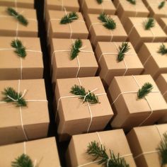 many wrapped presents are tied with twine and pine needles