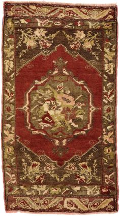 an antique rug with red and green colors