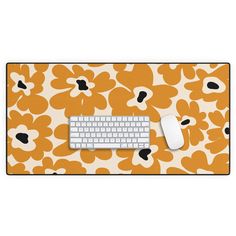 an orange and white flowered mouse pad with a computer keyboard on the left side