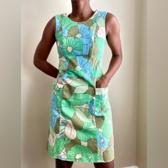 New Without Tags. Green, Blue, Creamy-Beige And Khaki Retro Floral Patterned Cotton Fabric With A Honeycomb Textured Finish. Sleeveless Design With Scoop Neckline And Concealed Back Zip Fastening. Flattering Deep, Fitted Empire-Line Waistband And Gently Flared Skirt Section With Large Side Pockets. Fully Lined Smoke Free. Pet Free. Mod Sleeveless Lined Dress, Retro Sleeveless Beach Dress, Blue Sleeveless Retro Mini Dress, Spring Sleeveless Mod Dress, Blue Retro Sleeveless Mini Dress, Retro Blue Sleeveless Mini Dress, Retro Sleeveless Lined Dress, Sleeveless Retro Mini Dress With Retro Print, Sleeveless Vintage Dress With Retro Print