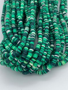 Cute green striped vinyl heishi beads. 300-400 beads per strand Size 6mm  Hole size 2mm  Length of strand 15-17" Cheap Green Necklace With Heishi Beads, Vinyl Disc, Beads Polymer Clay, Simple Bracelets, Types Of Gemstones, Beaded Top, Heishi Beads, Silver Bangle Bracelets, Polymer Clay Beads