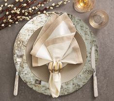 a place setting with silverware and napkins