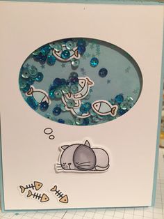 a card with an image of a cat sleeping on the floor next to fish and bubbles