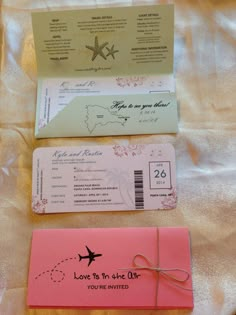 two boarding cards and an envelope on a bed