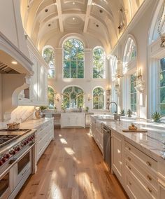 a large kitchen with an arched ceiling and white cabinetry, along with hardwood flooring