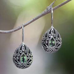 Yuniati captures the paradisiacal essence of Bali in the elegant design of these earrings. Shaped like teardrops they treasure the green translucency of peridot. .925 Sterling silver Green Teardrop May Birthstone Earrings, Green Teardrop Earrings For May Birthstone, Green Drop Earrings, Pierced, Green Pierced Drop Earrings, Pierced Teardrop Earrings With May Birthstone, Green Teardrop Filigree Earrings, Green Filigree Teardrop Earrings, Green Teardrop Dangle Earrings, Green Pierced Teardrop Dangle Earrings