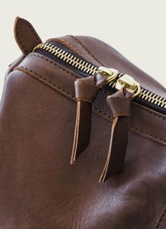 The Pan Am Duffle Bag is the perfect companion for your next weekend getaway or round-the-world trip. It's made from full-grain leather and features an adjustable strap, luggage tag, Heavy-duty 2-way zipper, and room to monogram it with your initials. Plus, it comes with a lifetime guarantee - so you can count on it to last through your many journeys. Materials Features Dimensions 100% Full-Grain Leather Heavy-duty 2-way zipper Solid Brass Hardware Luggage Tag Adjustable strap Interior pocket Ai Luxury Leather Backpack For Travel With Zipper Closure, Luxury Brown Weekender Bag With Zipper Closure, Luxury Leather Backpack With Leather Trim For Travel, Luxury Leather Duffle Bag With Zipper Closure, Everyday Leather Travel Bag With Zipper, Modern Duffle Bag With Leather Lining For On-the-go, Leather Duffle Bag With Zipper For On-the-go, Luxury Leather Backpack With Luggage Sleeve For On-the-go, Luxury Travel Bag With Zipper Closure For Everyday Use