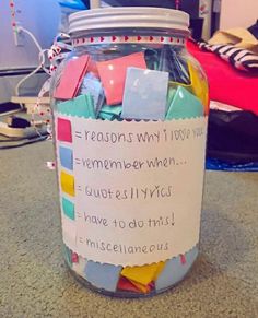 a jar filled with lots of papers on top of a table