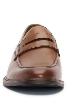 An apron toe and classic penny keeper accentuate the streamlined style of a luxe leather loafer designed with tonal stitching for timeless appeal. Leather upper/synthetic and textile lining/rubber sole Imported Classic Cognac Moc Toe Loafers, Classic Leather Fitted Moccasins, Classic Brown Fitted Loafers, Brown Fitted Classic Loafers, Brown Moc Toe Loafers Comfort Fit, Fitted Brown Moc Toe Loafers, Fitted Classic Leather Loafers, Fitted Moc Toe Loafers For Business Casual, Classic Fitted Loafers With Stitched Sole