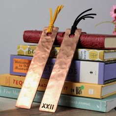 two bookmarks sitting on top of some books