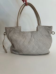 Elevate your bag collection with our Veronica Woven Tote Bag in Beige. This luxurious tote features an intricate braided design that showcases exceptional craftsmanship and timeless style. Made from high-quality materials, it combines durability with elegance, making it perfect for everyday use or special occasions. The spacious interior offers ample room for all your essentials, while the versatile beige color complements any outfit, adding a touch of sophistication to your look. Material: 100% Elegant Straw Tote Bag For On-the-go, Luxury Satchel With Braided Handles, Luxury Satchel With Braided Handles For Travel, Luxury Shoulder Bag With Braided Double Handles, Luxury Bags With Braided Double Handles, Luxury Straw Tote Bag With Rolled Handles, Modern Satchel With Intrecciato Weave For Daily Use, Modern Bags With Intrecciato Weave For Everyday Use, Elegant Woven Leather Hobo Bag For Travel