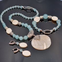 IDEAL FOR? ------- This set is made of natural aquamarine and mother of pearl   (necklace+bracelet+pendant+earrings) will suit your mom, sister, wife, best gift for birthday, anniversary, Valentine's Day, graduation, Mother's Day, etc., etc., etc., etc. . etc. etc. etc. -------This original modern designer set is ideal for both casual and business looks. ------- The set is assembled by hand - it is unique, has its own charm and emphasizes your individuality and beauty. Elegant Amazonite Jewelry Gift, Elegant Amazonite Jewelry For Gifts, Handmade Light Blue Aquamarine Jewelry, Elegant Handmade Larimar Jewelry, White Larimar Round Jewelry, Elegant Turquoise Jewelry With Mother Of Pearl, Handmade White Larimar Jewelry, Elegant White Larimar Jewelry, Elegant Turquoise Mother Of Pearl Jewelry