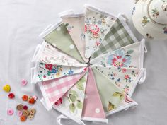 I've had lots of requests for a smaller version of my popular floral garden bunting for smaller areas such as windows, along shelves etc so here it is! This is a mini version of my cottage garden bunting and is made up of a selection of vintage fabrics from Cath Kidston, Laura Ashley and Clarke & Clarke, in pinks and greens, floral, gingham and Spotty. The bunting is made of double-sided flags, each measuring 10cms by 13cms approx. (with 5m gaps) and sewn onto white cotton tape.  The total lengt Bunting Ideas, Garden Bunting, Work Room, Vintage Cottage, Cath Kidston, Floral Garden, Vintage Fabrics, Laura Ashley, Cottage Garden