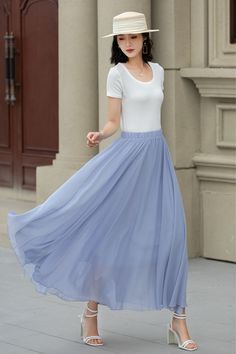 A trendy light blue A-line midi chiffon skirt, perfect for breezy summer days. The elastic waist ensures maximum comfort, making it a must-have for any fashionista. Elevate your summer wardrobe with this chic piece!  DETAILS: * Chiffon skirt * Polyester lining * No pockets * High-waisted cinched hem * Elasticized waist closure * Swing skirt * Mid-length skirt * A-line skirt * Suitable for spring, summer and fall wear * Machine washable in cold/warm water, do not bleach/medium iron/line dry * Suitable for daily wear/wedding/bridesmaid dresses/vacation/date night/graduation/party etc. CUSTOM MADE SERVICE If you * Change other color * Can't find your size in our size Chart * Change the Style * Change the length * Your Height is not Between 5'1" - 5"9" * Your weight is not Between 47 kg - 75kg Flowy A-line Maxi Skirt With Lining, Chic Blue A-line Maxi Skirt, Solid Chiffon Skirt For Spring, Elegant Flowy Blue Skirt, Elegant Blue Chiffon Skirt, Summer Solid Color Chiffon Maxi Skirt, Summer Flowy A-line Bottoms, Flowy Light Blue Lined Maxi Skirt, White Chiffon Maxi Skirt