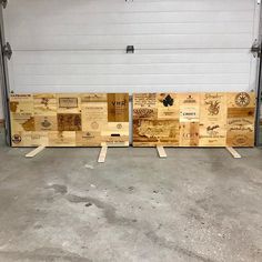 three pieces of wood sitting next to each other in front of a garage door with the doors open