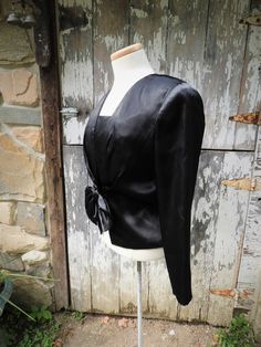 "GREAT New Old Stock Vtg 1980's Prophecy Black Sateen Dress Blouse Shoulder Pads sz S/6 This is a lovely vintage black sateen blouse from the 1980's. It is new old stock and does appear unworn or washed to me. It's in great condition. The collar is squared off like a sailor shirt. It is secured at the front with a snap and hook just under the large bow which sits at the waistline. The front has a rushed collar line and there are large shoulder pads here. This blouse is lined and marked a vintage Vintage V-neck Blouse For Party, Vintage V-neck Blouse For Evening, Vintage V-neck Party Blouse, Retro Long Sleeve Evening Blouse, Retro Long Sleeve Blouse For Evening, Retro V-neck Blouse For Party, Vintage Tops For Fall Weddings, Fitted Vintage Top For Night Out, Fall Vintage Tops For Wedding