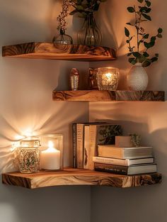 two wooden shelves with candles and books on them