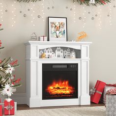 a white fireplace with christmas decorations around it