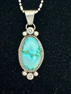 A Native American Navajo Turquoise 18" Sterling Silver Necklace made by the Sunwest workshop  in Albuquerque, New Mexico. The pendant might be small in size, but delicate enough to show its beauty. The necklace is stamped sterling silver. Western Teardrop Jewelry Gift, Southwestern Style Large Oval Pendant Necklace, Southwestern Sterling Silver Necklaces With Round Pendant, Southwestern Sterling Silver Necklace With Round Pendant, Southwestern Sterling Silver Oval Pendant Necklace, Southwestern Turquoise Oval Pendant Necklace, Southwestern Turquoise Necklace With Oval Pendant, Southwestern Style Turquoise Oval Pendant Necklace, Untreated Bohemian Turquoise Necklace For Collectors