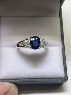 One CCJ (c), 18K White Gold, Natural 1.562ct Carat Oval Sapphire and Diamond Ring. The Ring measures 7.9mm in Width at the Top and 2.5mm+ in Width at the Bottom of the Shank. There is One Natural 1.564ct Oval Shaped Sapphire (1=OV/S-1.564ct, VS+), 6 Chanel Set Princess Cut Diamonds (6-PRN-.45ct+ tcw, G/H-VS/SI1+) and Two Brilliant Round Cut Diamonds (2-BR-.20ct+, G/H-SI1+). The Ring is a Size 6 1/2+, weighs 5.960 grams and has the proper hallmarks. (see photos). Retail $3650. Shipping will be First Class Mail, and will require a signature for delivery! RETURNS, will be accepted only in the event that the item has been misrepresented! We have been in the jewelry business in excess of 40 years, and every effort is made for an accurate description of our items (including a GIA Graduate Gemolo Chanel Set, Sapphire And Diamond Ring, Jewelry Business, Princess Cut Diamonds, Round Cut Diamond, Princess Cut, 40 Years, Round Cut, Diamond Ring