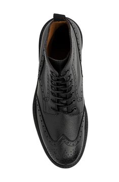 Broguing highlights the style of an Italian leather wingtip boot that is a classic addition to any wardrobe. 6.6" shaft height Round wingtip toe Broguing details Lace-up Leather upper, manmade sole Made in Italy