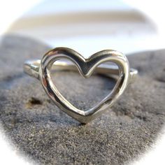 Sterling Silver Heart Ring~ Send a gift of love, let your loved one know they are loved with this sweet heart ring. Custom made for you, each ring is hand forged with sterling silver and hammered and polished to a beautiful shine. Great gift for the sweetheart in your life! *This listing is for 1 sterling silver heart ring made with 14 gauge wire.* Each ring is a one of a kind, hand shaped and hammered and will vary. Also available in 14k gold fill~ https://www.etsy.com/listing/111604268/gold-he Surfer Girl Gifts, Gold Wave Ring, Gold Waves, Silver Heart Ring, Rings For Girls, Thumb Rings, Maui Hawaii, Sterling Silver Bands, Sterling Silver Heart