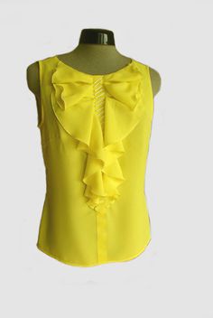 Bright yellow chiffon top, decorated with flounces, yellow ribbon and handstiched beads. Sleeveless. Loose fit.Size 42/12  (bust 96cm/37,8in, waist 78cm/30,7in)Back lenght: 57cm/22,3inMaterials utilised100% Polyester chiffonYellow ribbon.Long beads. Sleeveless Ruffled Chiffon Top, Sleeveless Chiffon Top With Ruffles, Sleeveless Chiffon Ruffle Top, Yellow Ruffled Blouse For Party, Elegant Yellow Summer Blouse, Yellow Sleeveless Blouse For Party, Sleeveless Chiffon Blouse With Ruffles, Sleeveless Ruffled Chiffon Blouse, Elegant Yellow Sleeveless Blouse