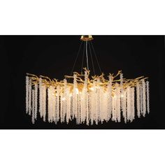 a large chandelier with many lights hanging from it's sides and fringes