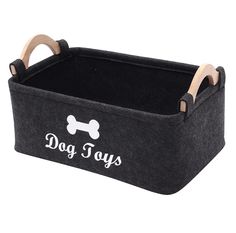 a dog toy basket with wooden handles and a bone print on the front, black